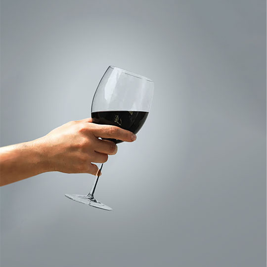 A hand holding a Wine Glass